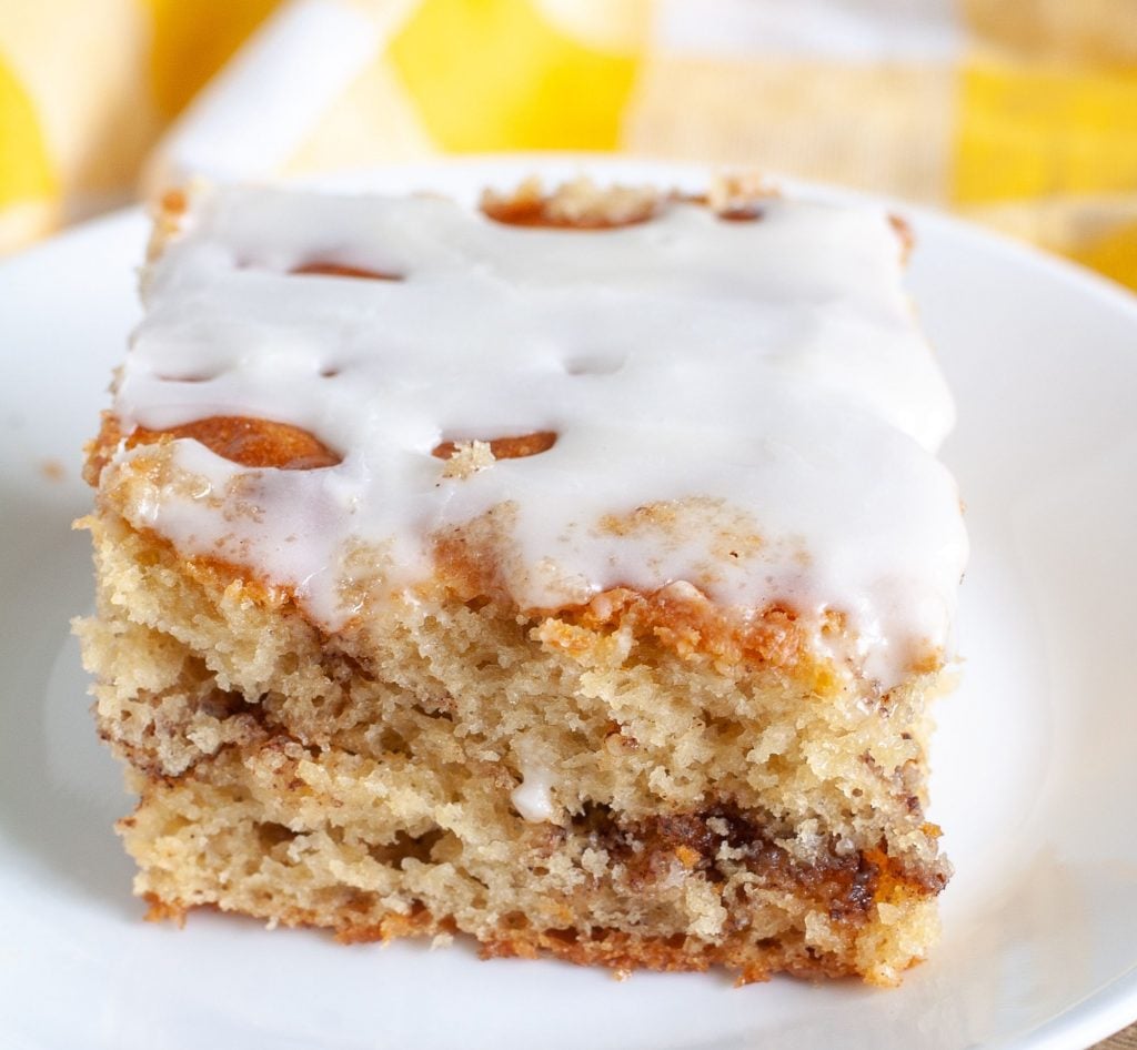 Piece of coffee cake on a plate with yellow napkin