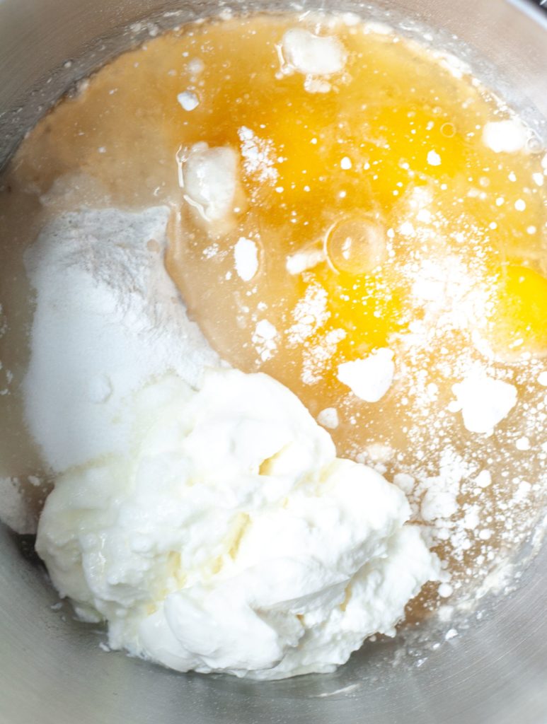 Eggs, sour cream, cake mix, and oil in a mixing bowl. 