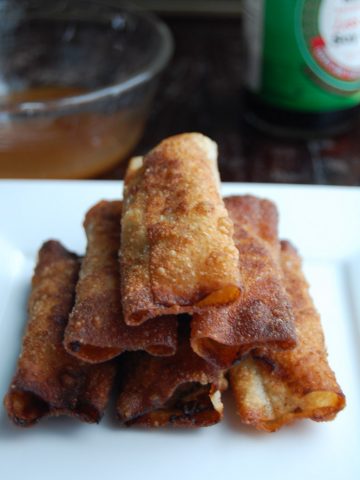 Stacked lumpia on plate.