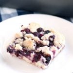 Piece of blueberry cake on plate.