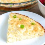 Quiche with green onion on a plate.