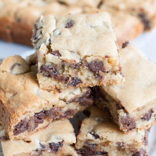 Chocolate chip bars cut into squares on a plate.
