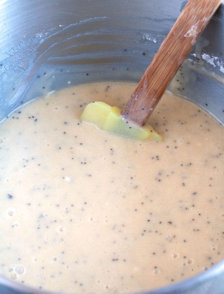 Cake batter in a mixing bowl with spatula