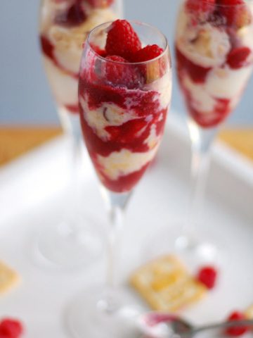 Champagne glass with ice cream and raspberries.