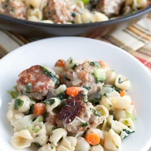 Mini pasta shells with meatballs on a plate.