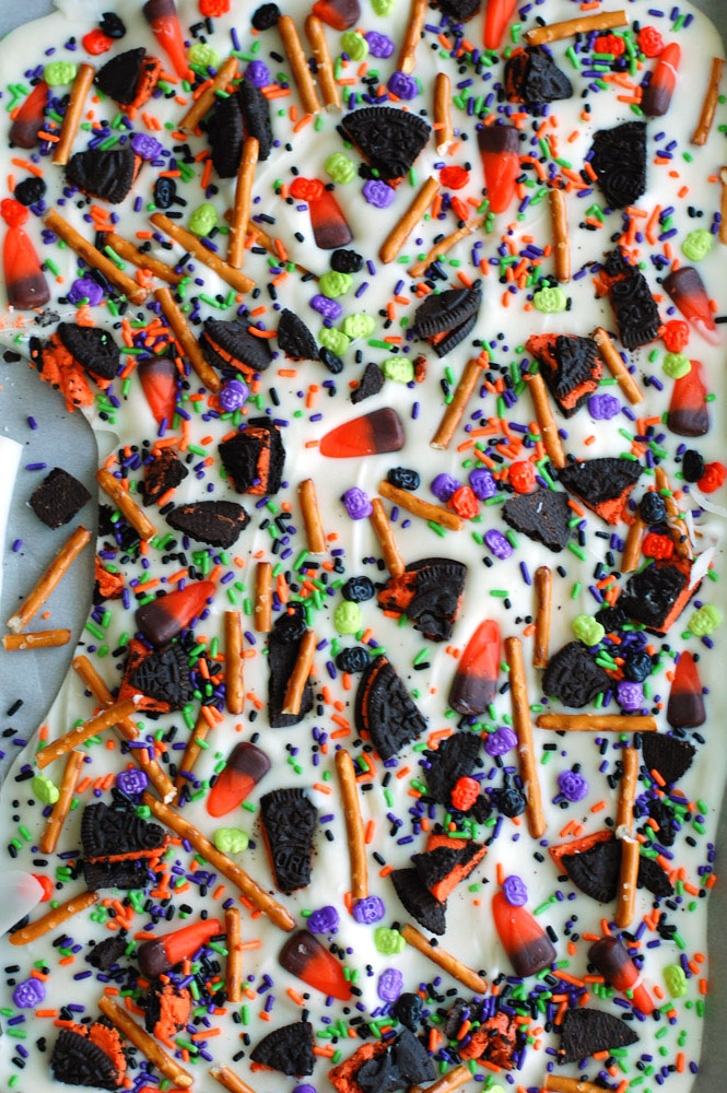 Halloween Candy Bark is easy and fun to make! Use your favorite candies and sprinkles to make this festive treat.