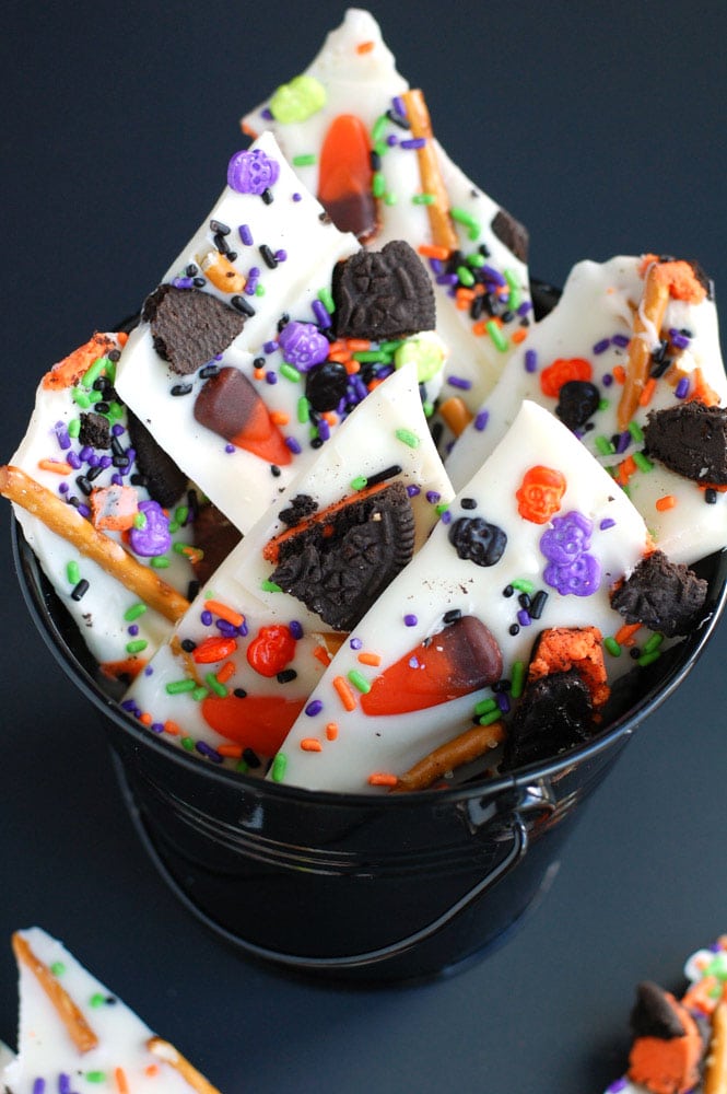 Halloween Candy Bark is easy and fun to make! Use your favorite candies and sprinkles to make this festive treat.