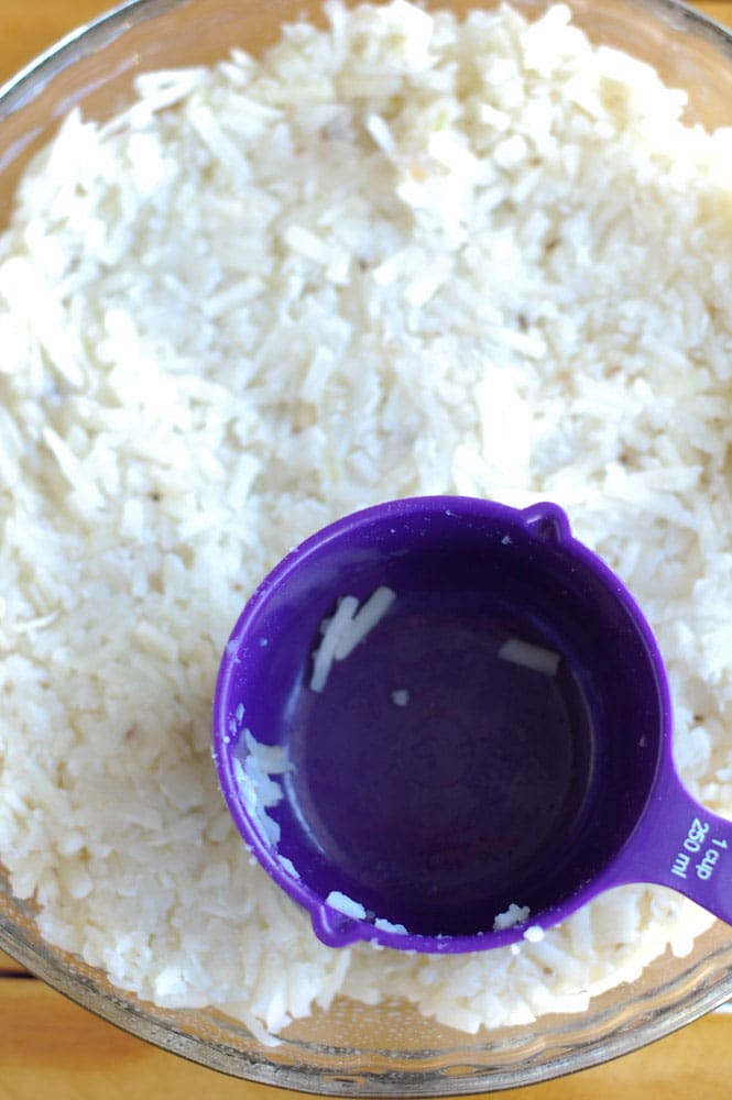 Hash browns in a pie plate with measuring cup