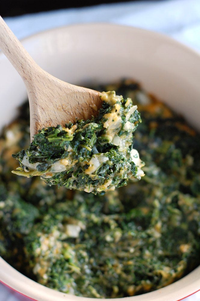 creamed spinach on a wooden spoon