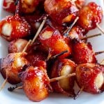 Bacon wrapped water chestnuts on plate.