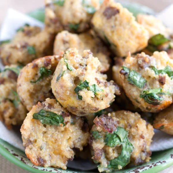 Egg and sausage cups piled on a plate.