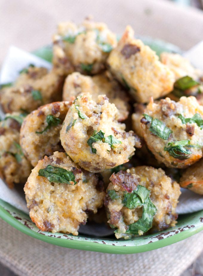 Egg and sausage cups piled on a plate. 