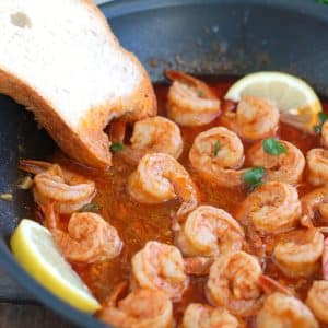 BBQ Shrimp in skillet with slice of bread.