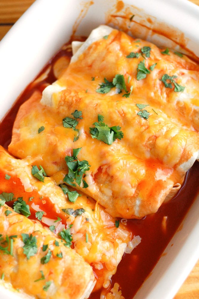 Casserole dish with butternut squash and black bean enchiladas