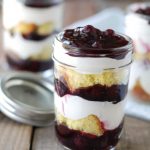 Jar filled with blueberry and cake dessert.