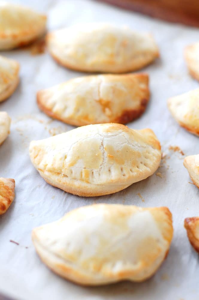 Baked empanadas on a baking sheet