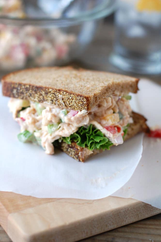 Sandwich on parchment paper on a cutting board