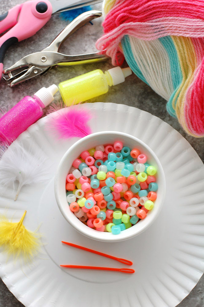 Bowl of beads, glitter glue and yarn