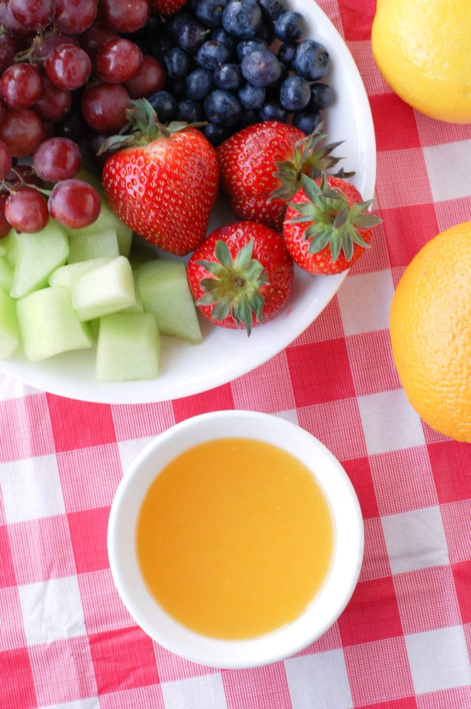 A refreshing orange dip that is perfect for dipping your summer fruit.