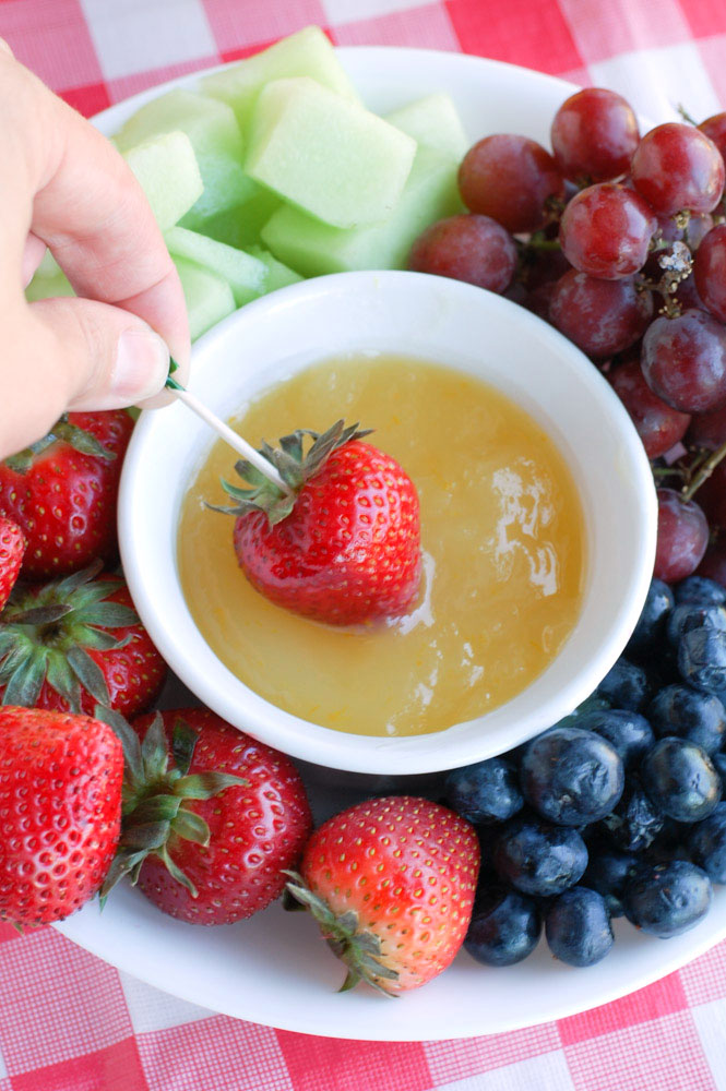 A refreshing orange dip that is perfect for dipping your summer fruit.