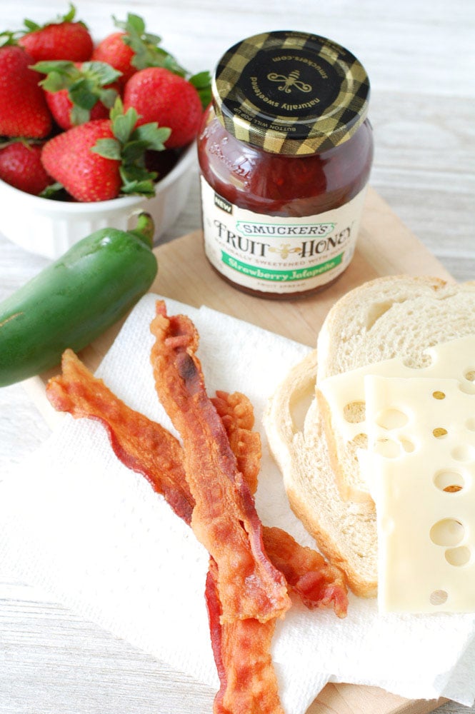 This Strawberry Jalapeno Bacon Grilled Cheese Sandwich is a crunchy, gooey combination of savory, sweet, and salty with just a touch of heat. To the delight of taste buds everywhere, sourdough bread, bacon, Swiss cheese and strawberry jalapeno fruit spread join together to create this tasty sandwich!