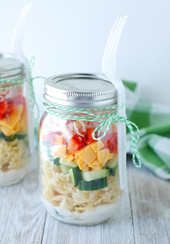 Jar filled with pasta salad. 