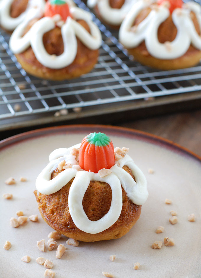 Pumpkin toffee mini bundt cakes are a delicious way to celebrate fall. Pumpkin cake filled with toffee chips and topped with buttercream icing.