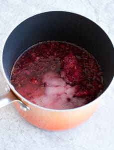 Sparkling cranberry lime mocktail Saucepan with cranberry simple syrup
