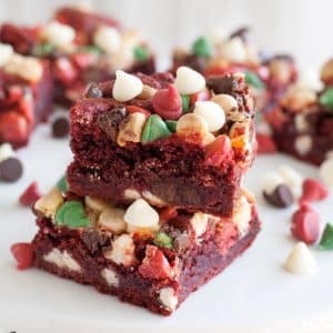 Stacked red velvet cookie bars with chocolate chips.