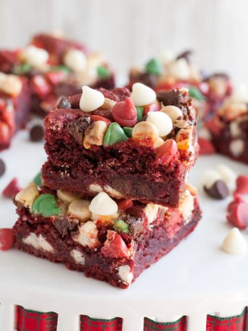 Stacked red velvet cookie bars with chocolate chips.