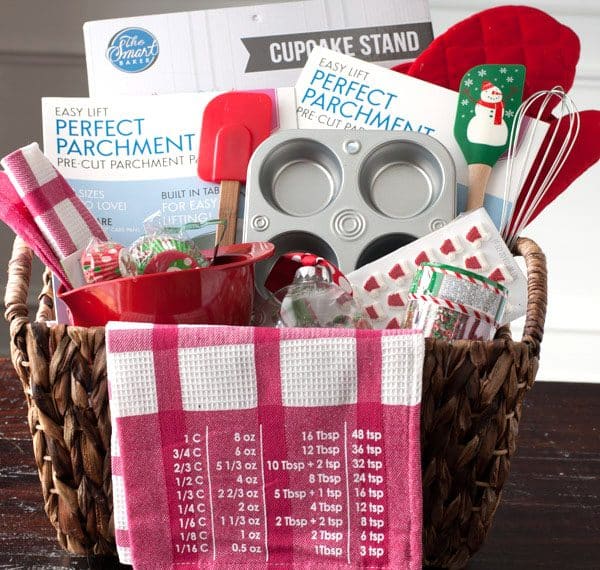 Basket with muffin tin, spatulas and towels.