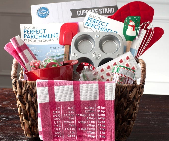 Basket with muffin tin, spatulas and towels. 