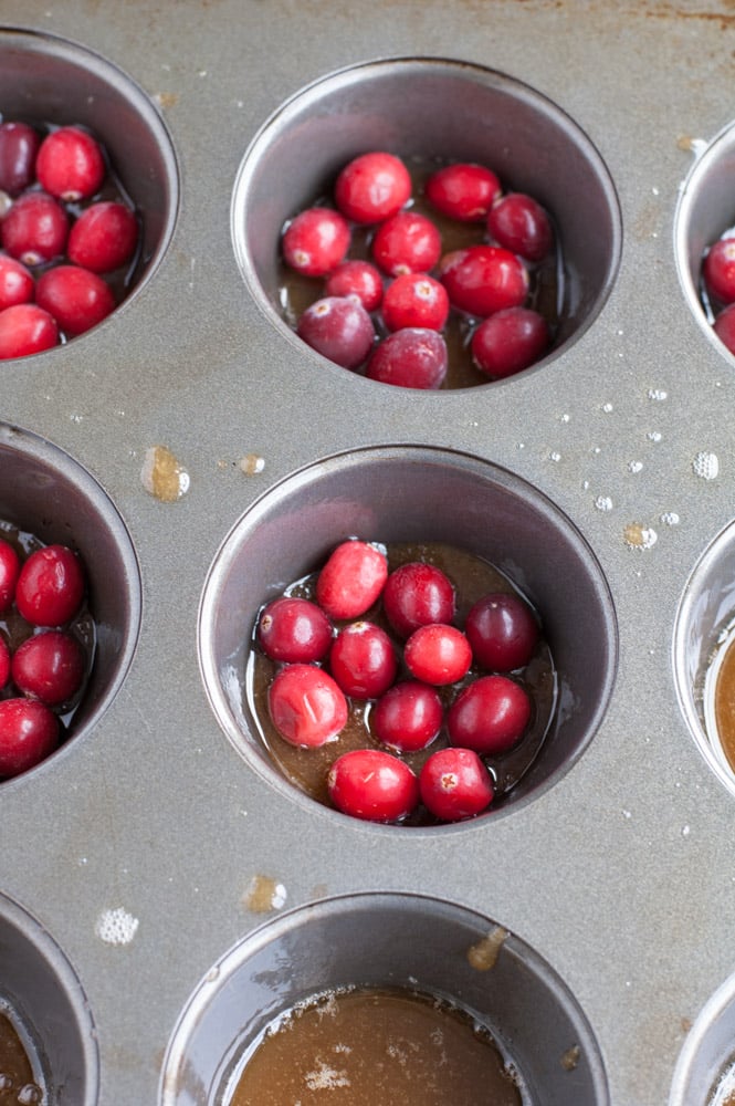 Mini cranberry orange upside down cakes are great for a party or holiday gathering. Made with fresh or frozen cranberries, brown sugar, butter and an orange cake.