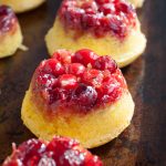 Mini cranberry upside down cakes on a pan.