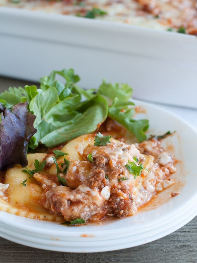 Baked Ravioli Lasagna on a plate with salad