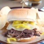 Shredded beef sandwich with cheese and peppers.