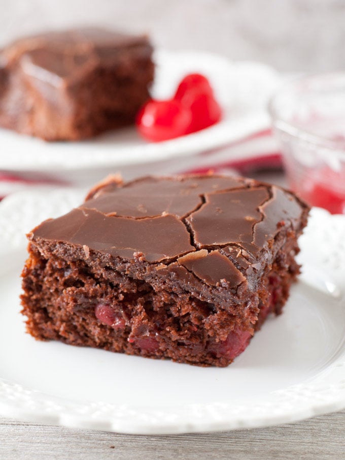 Easy chocolate cherry cake is a moist and delicious chocolate cake filled with cherries and topped with chocolate ganache.