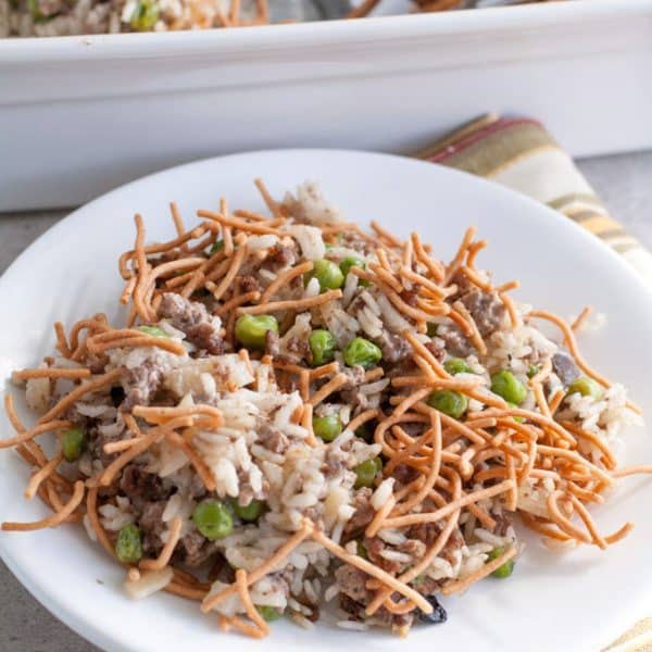 Beef and rice casserole with crunchy noodles on plate.