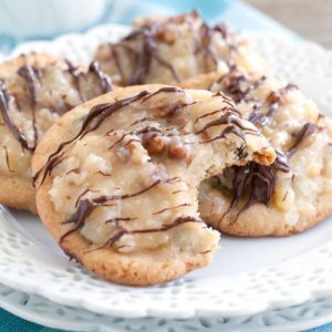 Chocolate chip cookies with frosting on a plate.