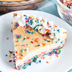 Plate of cheesecake with sprinkles.