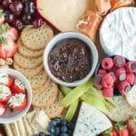 Cheese and fruit on a wooden circle tray