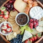 Plate with crackers, fruit and cheese.