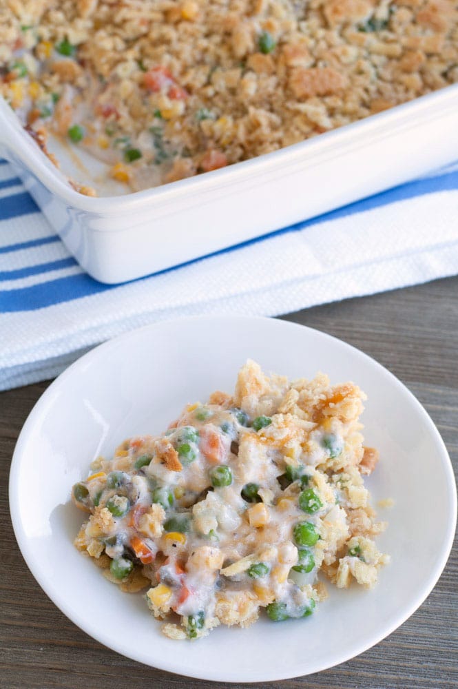 Plate of casserole with peas and carrots. 