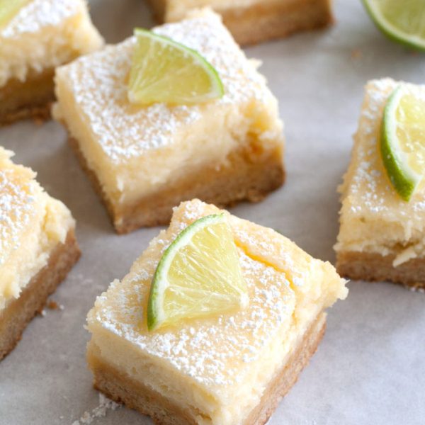 Cheesecake squares with slice of lime on top.
