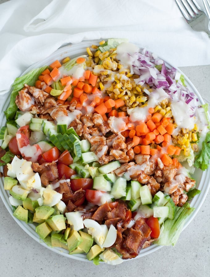 Salad with eggs, bacon, chicken and corn. 