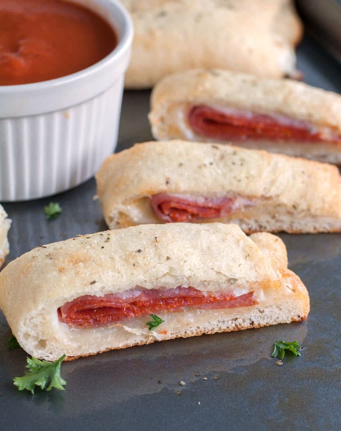 Slices of stromboli with sauce on a plate