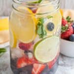 Jar of water with lemon, lime, blueberries and stra