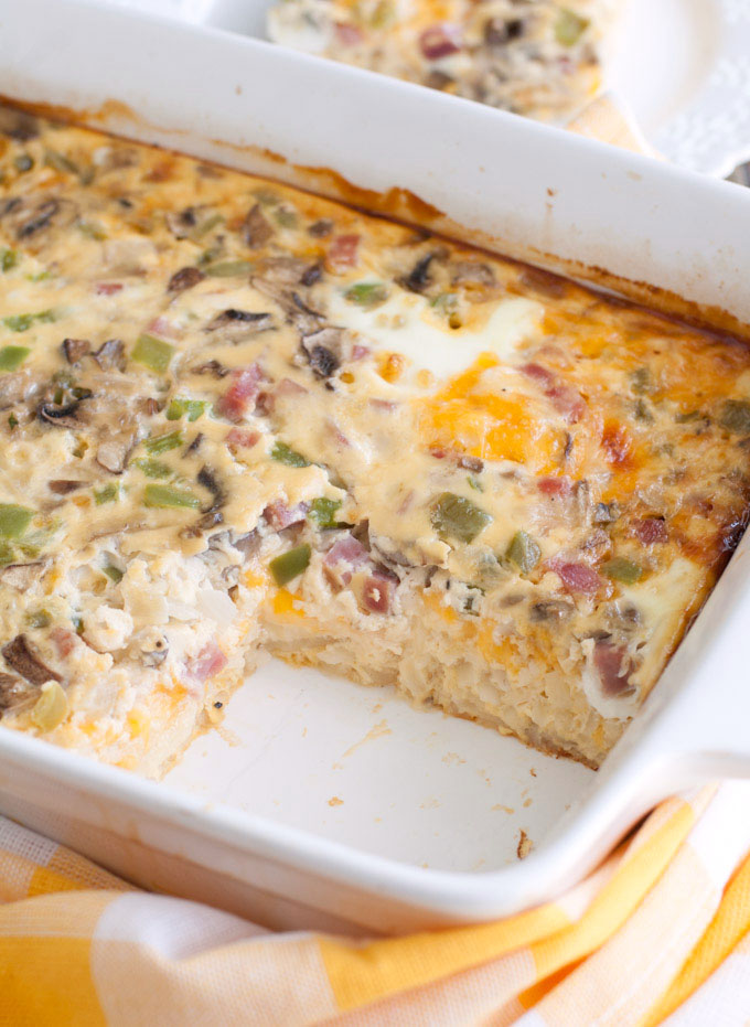 Western Omelet Breakfast Casserole in a casserole dish with yellow cloth