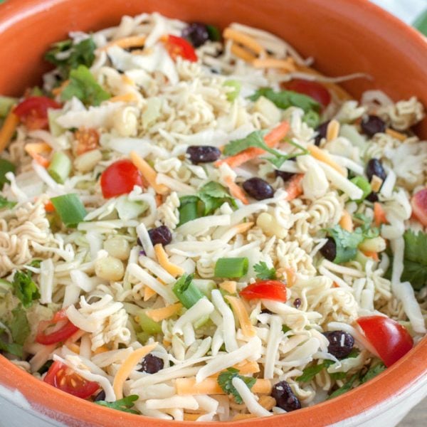 Large bowl of salad with olives, tomatoes and cheese.