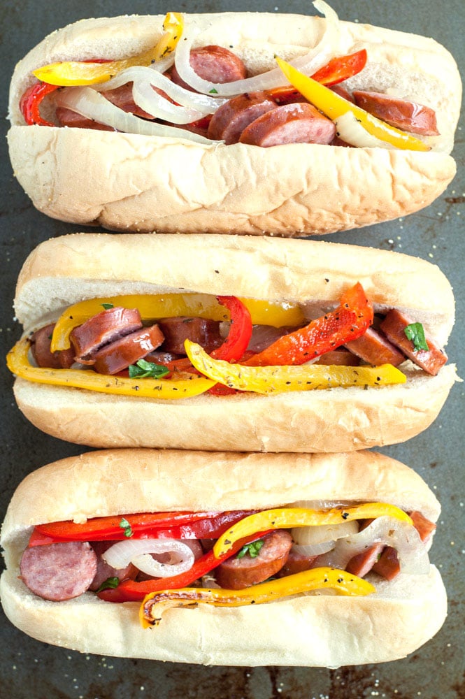 sausage and pepper sandwiches on a cookie sheet